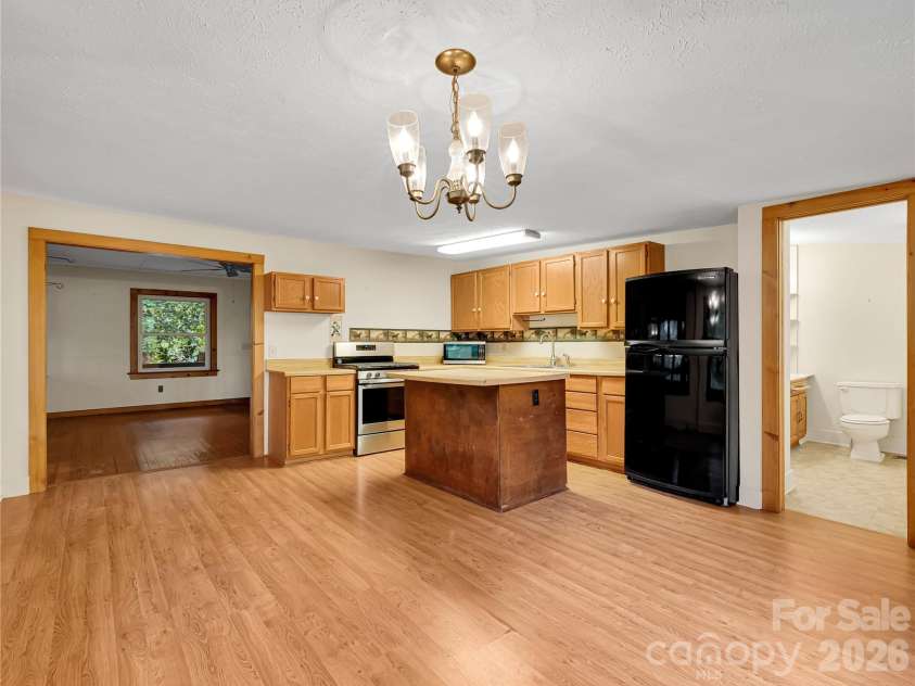 989 Fox Mountain Road, Columbus, NC 28722.  MLS# CAR4423345, YatesRealty ID 50694. Kitchen has a sloped ceiling that is under 8' at the lower end.