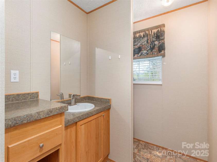 9 Scotty Circle, Candler, NC 28715.  MLS# CAR4242801, YatesRealty ID 5080. Hall Bathroom