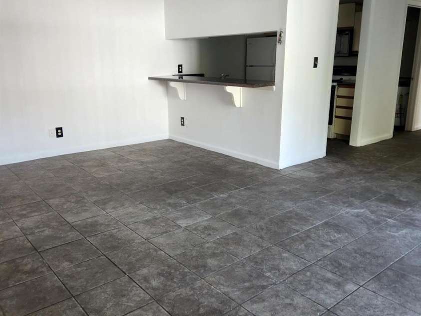 9523 University Terrace Drive, Charlotte, NC 28262.  MLS# CAR4424623, YatesRealty ID 50830. Den looking toward kitchen