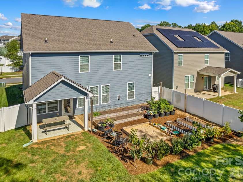 117 Candlelight Way, Mooresville, NC 28115.  MLS# CAR4424260, YatesRealty ID 50858. Back yard features raised garden beds