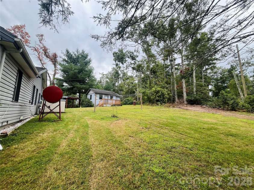 74 Vaughn Road, Spruce Pine, NC 28777.  MLS# CAR4424283, YatesRealty ID 50876. Backyard of home with clothes line
