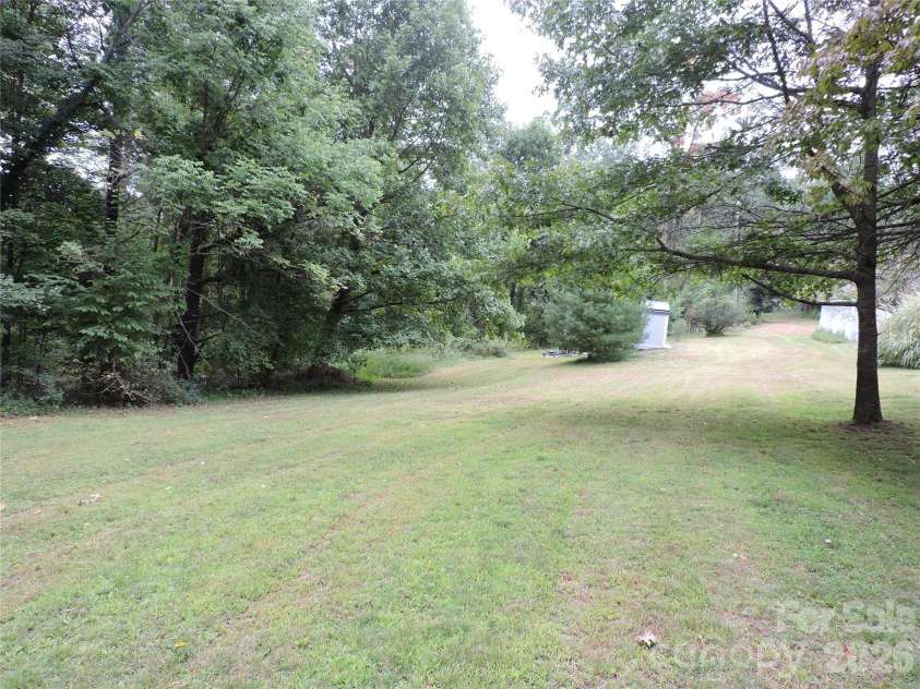 74 Vaughn Road, Spruce Pine, NC 28777.  MLS# CAR4424283, YatesRealty ID 50876. Left side yard