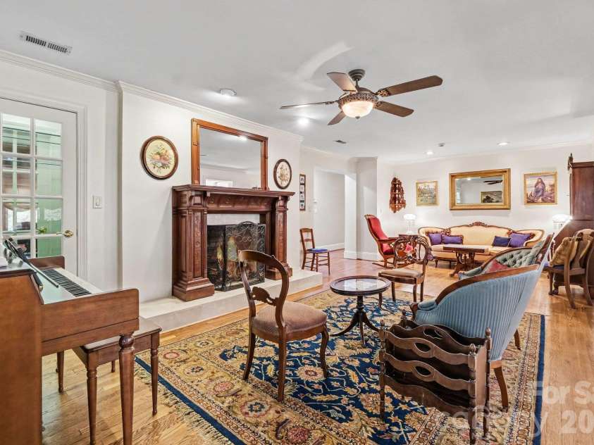 746 Grandview Drive, Concord, NC 28025.  MLS# CAR4434570, YatesRealty ID 5093. Versatile living/dining/flex area features a display closet and gas fireplace with a beautiful custom mantle