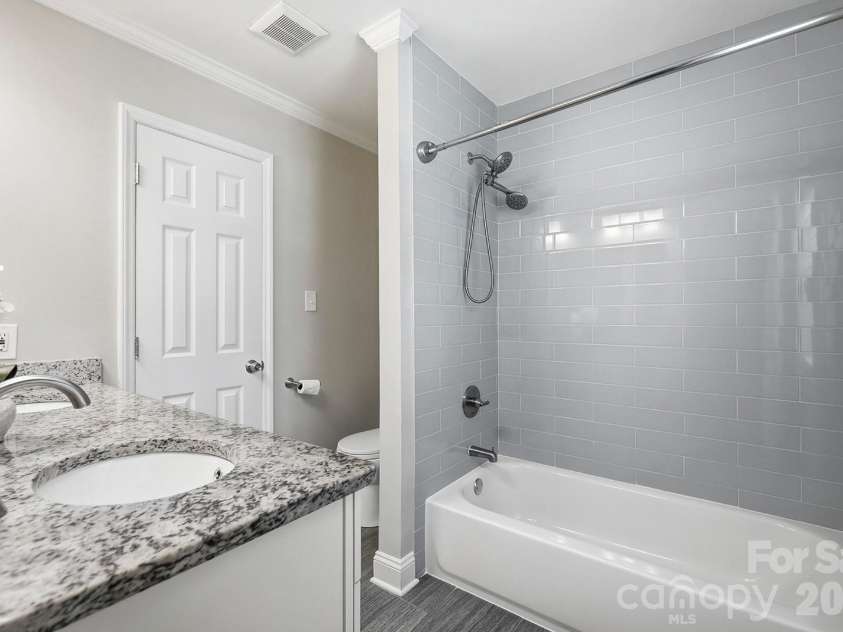 4400 Strangford Avenue, Charlotte, NC 28215.  MLS# CAR4422804, YatesRealty ID 50980. Full bath upstairs with updated tile (gray)