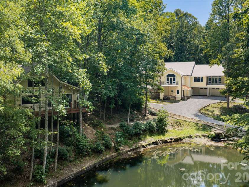 3999 Laurel Park Highway, Hendersonville, NC 28739.  MLS# CAR4419689, YatesRealty ID 50998. Looking at both properties over pond