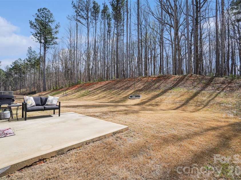 310 Hamptons Cove Road, Troutman, NC 28166.  MLS# CAR4355239, YatesRealty ID 5113. Wooded backyard