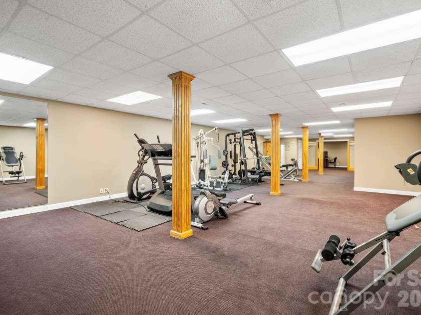 187 Duncan Creek Road, Fletcher, NC 28732.  MLS# CAR4424773, YatesRealty ID 51157. Finished basement gym area