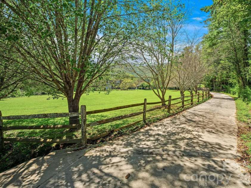 187 Duncan Creek Road, Fletcher, NC 28732.  MLS# CAR4424773, YatesRealty ID 51157. Private paved drive through the property