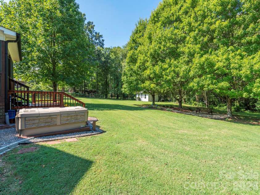 2434 Plantation Road, Concord, NC 28027.  MLS# CAR4425292, YatesRealty ID 51163. Backyard with hot tub
