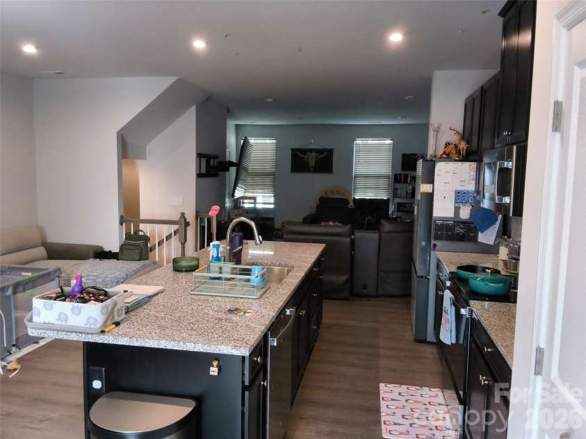 1205 May Apple Drive, Matthews, NC 28104.  MLS# CAR4425216, YatesRealty ID 51165. Kitchen to living room