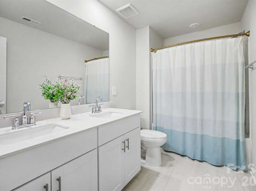 1623 Baymont Court, Stanley, NC 28164.  MLS# CAR4424072, YatesRealty ID 51244. A full guest bath with double sinks.