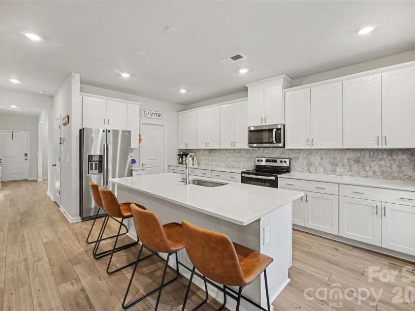 1623 Baymont Court, Stanley, NC 28164.  MLS# CAR4424072, YatesRealty ID 51244. A stylish kitchen with crisp white cabinetry.
