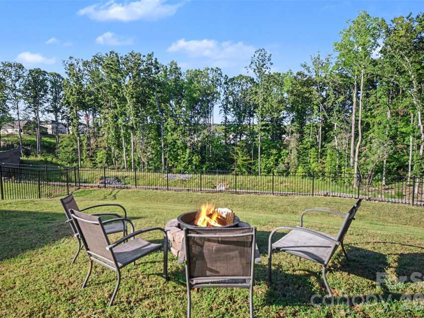 1623 Baymont Court, Stanley, NC 28164.  MLS# CAR4424072, YatesRealty ID 51244. Gather around the fire pit on cool evenings.
