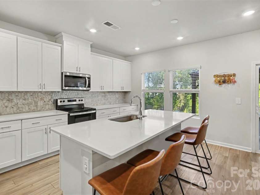 1623 Baymont Court, Stanley, NC 28164.  MLS# CAR4424072, YatesRealty ID 51244. The kitchen island offers extra seating and prep space.