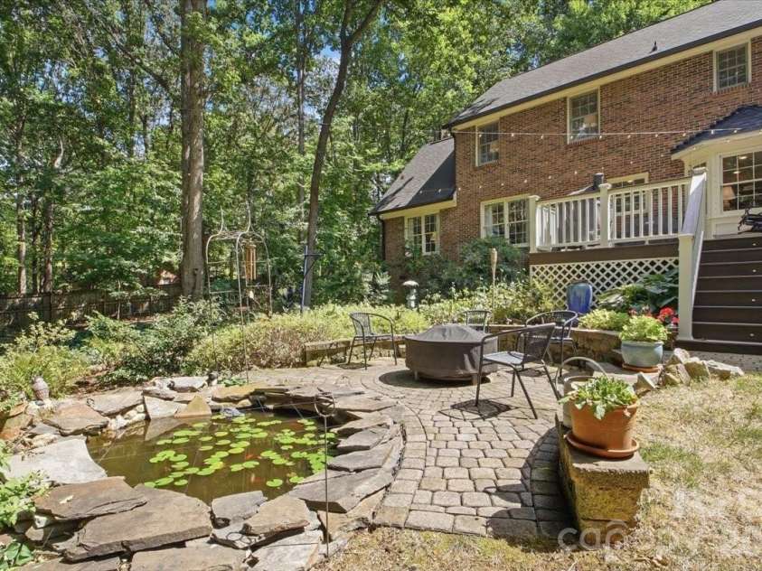 5138 Panhandle Circle, Matthews, NC 28104.  MLS# CAR4407389, YatesRealty ID 51282. Fire Pit Area with Small Pond5138 Panhandle CirWeddington, NC 28104
