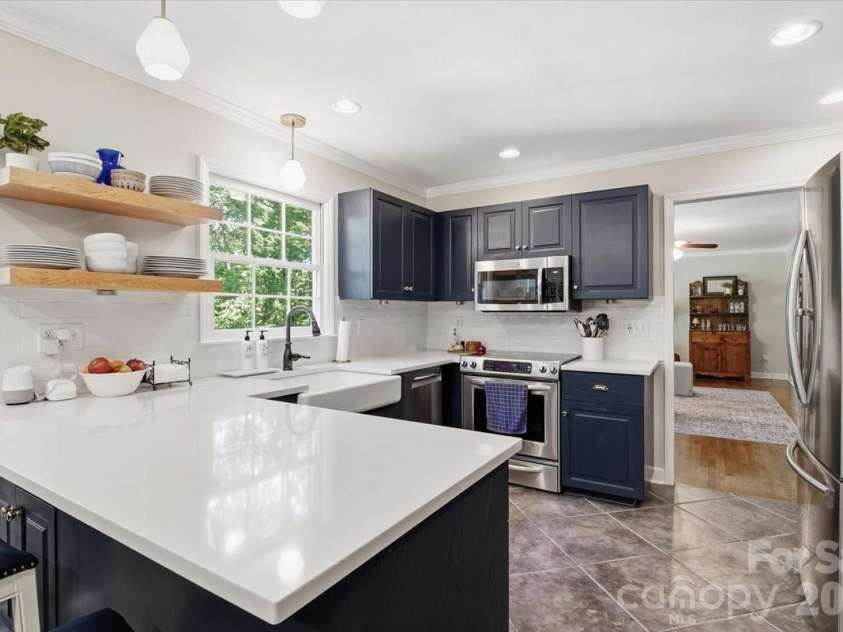 5138 Panhandle Circle, Matthews, NC 28104.  MLS# CAR4407389, YatesRealty ID 51282. Kitchen with Breakfast Bar5138 Panhandle CirWeddington, NC 28104