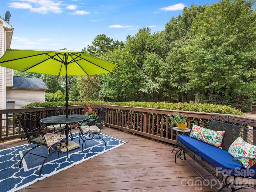 15606 Troubadour Lane, Huntersville, NC 28078.  MLS# CAR4425658, YatesRealty ID 51284. Take the party outside on this beautiful back deck, where a tree-lined buffer creates a peaceful backdrop for entertaining, relaxing, and enjoying a little extra privacy.