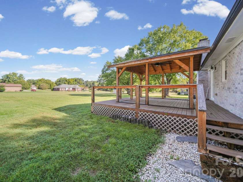 4410 Coddle Creek Drive, Concord, NC 28027.  MLS# CAR4422400, YatesRealty ID 51340. Back yard & porch with pergola