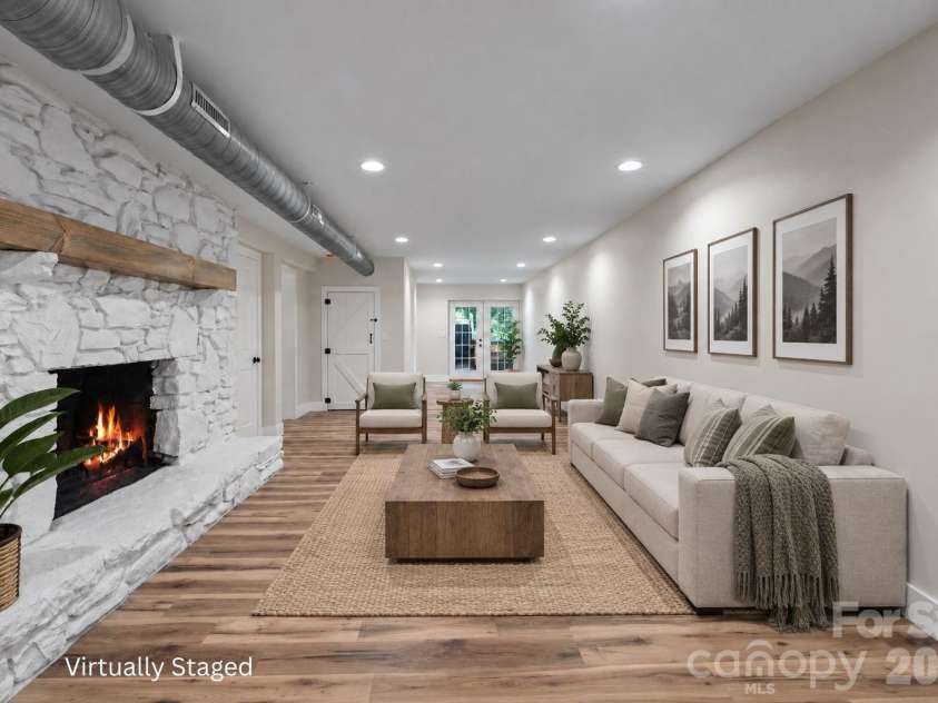 156 State Street, Asheville, NC 28806.  MLS# CAR4423069, YatesRealty ID 51393. Virtually Staged Lower-Level Den: Expansive den with a second stone wood-burning fireplace.