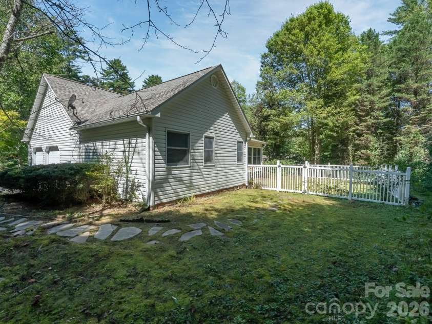 106 Fish Hawk Drive, Hendersonville, NC 28739.  MLS# CAR4425849, YatesRealty ID 51450. Side yard from driveway