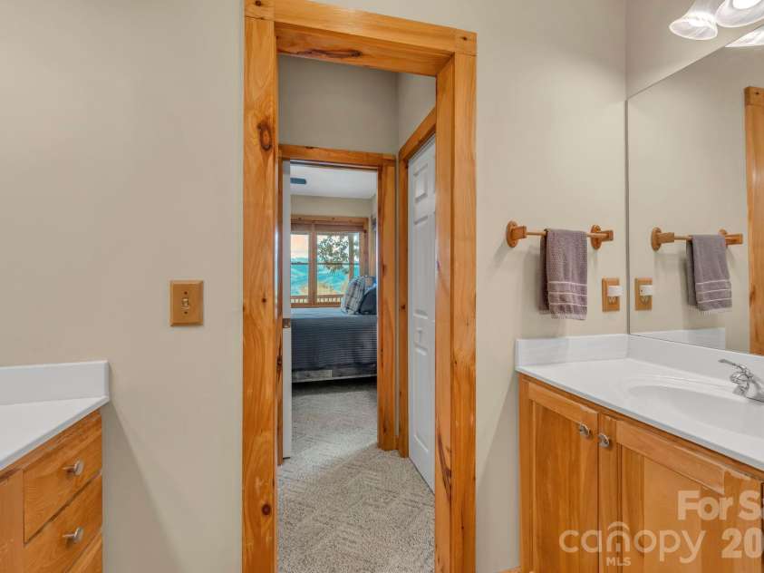 4880 Nightingale Lane, Lenoir, NC 28645.  MLS# CAR4423814, YatesRealty ID 51469. Main-level primary suite bath with dual closets & vanities