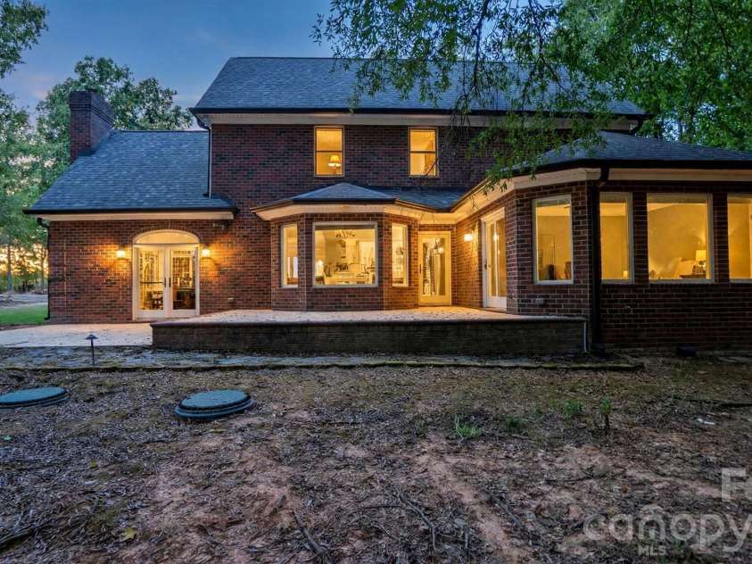 1517 Helms Short Cut Road, Monroe, NC 28112.  MLS# CAR4424290, YatesRealty ID 51519. Night view to back home patio
