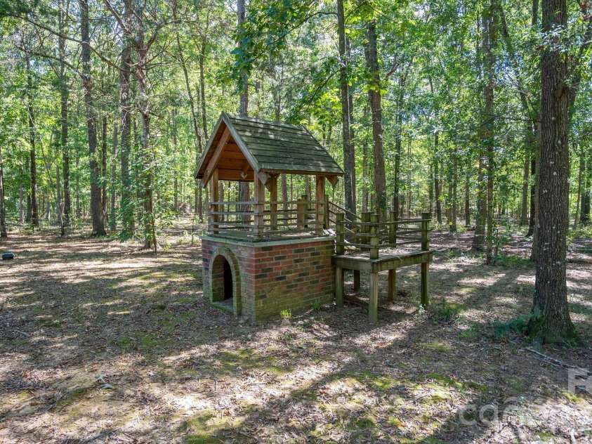 1517 Helms Short Cut Road, Monroe, NC 28112.  MLS# CAR4424290, YatesRealty ID 51519. Wooded back yard with play house