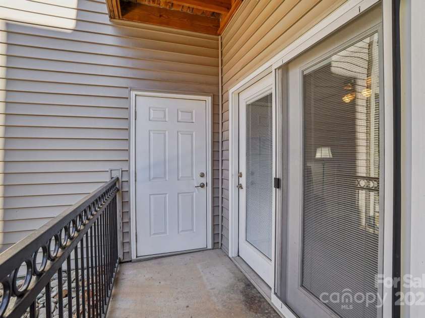 316 Appeldoorn Circle, Asheville, NC 28803.  MLS# CAR4316997, YatesRealty ID 51520. Outside patio with door to storage area
