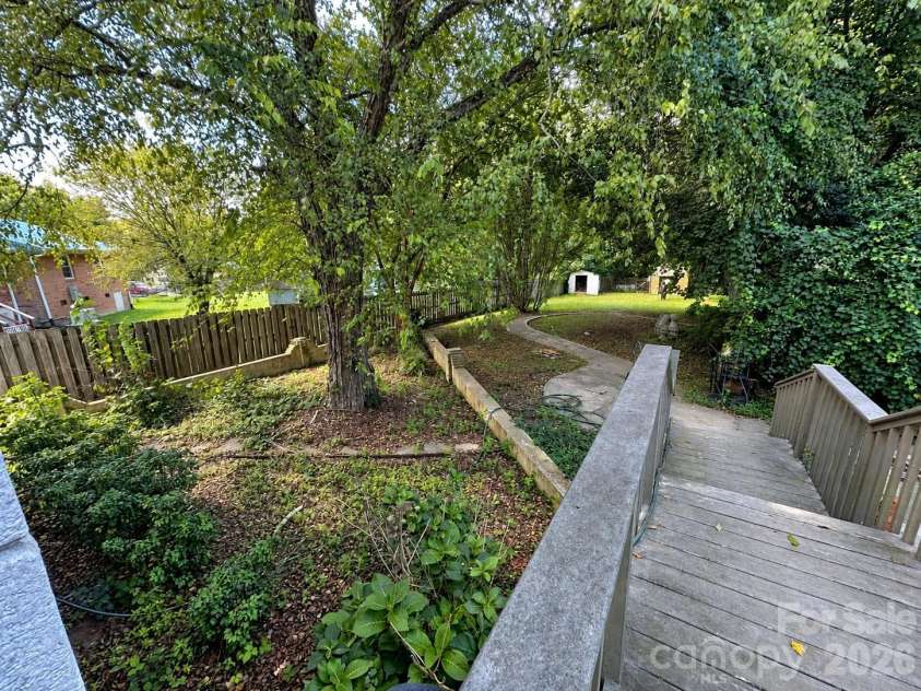 4711 Summit Avenue, Greensboro, NC 27405.  MLS# CAR4425186, YatesRealty ID 51545. Lush Backyard Garden Path