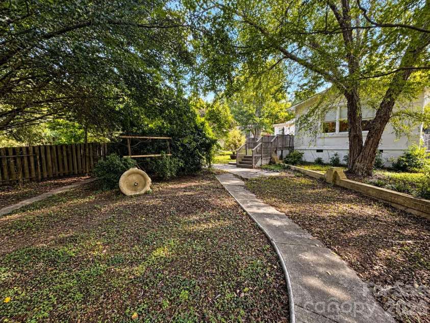4711 Summit Avenue, Greensboro, NC 27405.  MLS# CAR4425186, YatesRealty ID 51545. Shaded Backyard Path to Deck