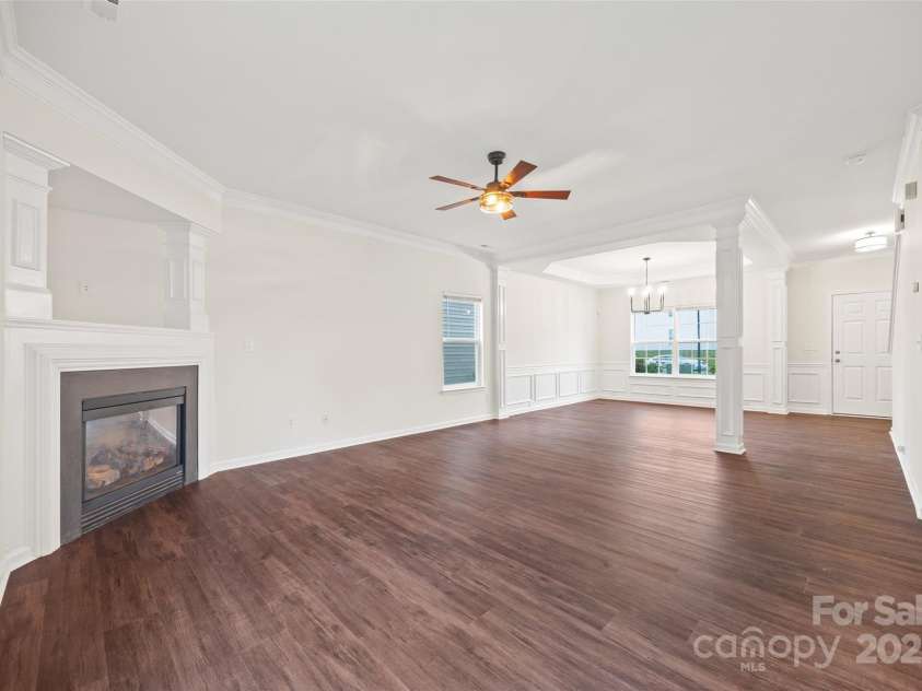 3725 Catawba Creek Drive, Gastonia, NC 28056.  MLS# CAR4240950, YatesRealty ID 5155. Large living room with gas fireplace, tv nook and stylish ceiling fan.