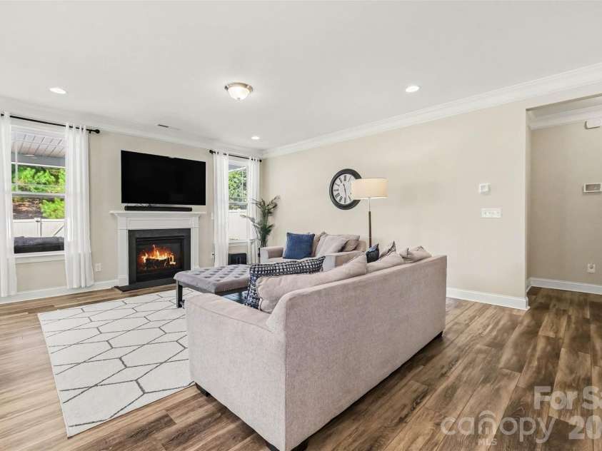 149 Longleaf Drive, Mooresville, NC 28117.  MLS# CAR4424546, YatesRealty ID 51571. Gas burning fireplace, flanked by windows that offer backyard views.