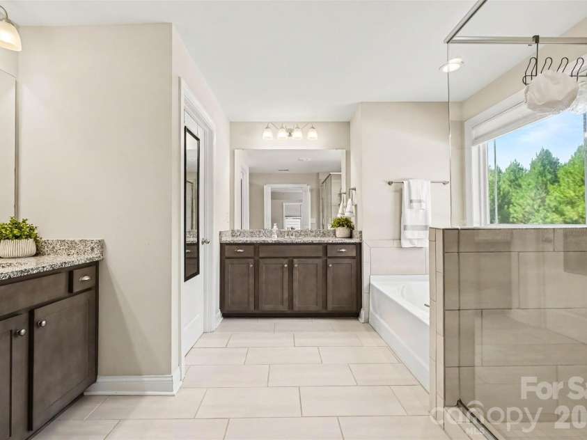 149 Longleaf Drive, Mooresville, NC 28117.  MLS# CAR4424546, YatesRealty ID 51571. Spa bath with double vanities, tile and granite.