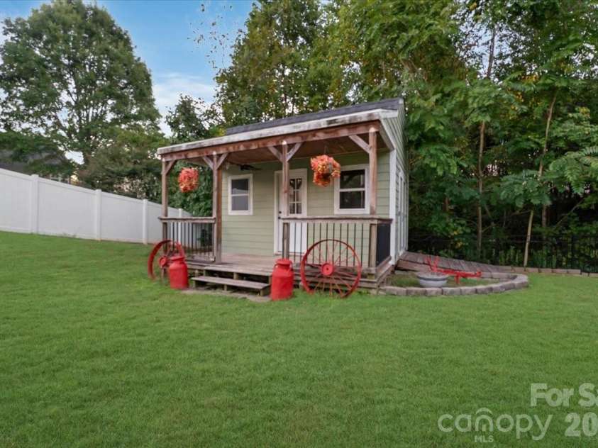 144 Steeplechase Avenue, Mooresville, NC 28117.  MLS# CAR4424163, YatesRealty ID 51592. Charming backyard shed that adds both function and character.