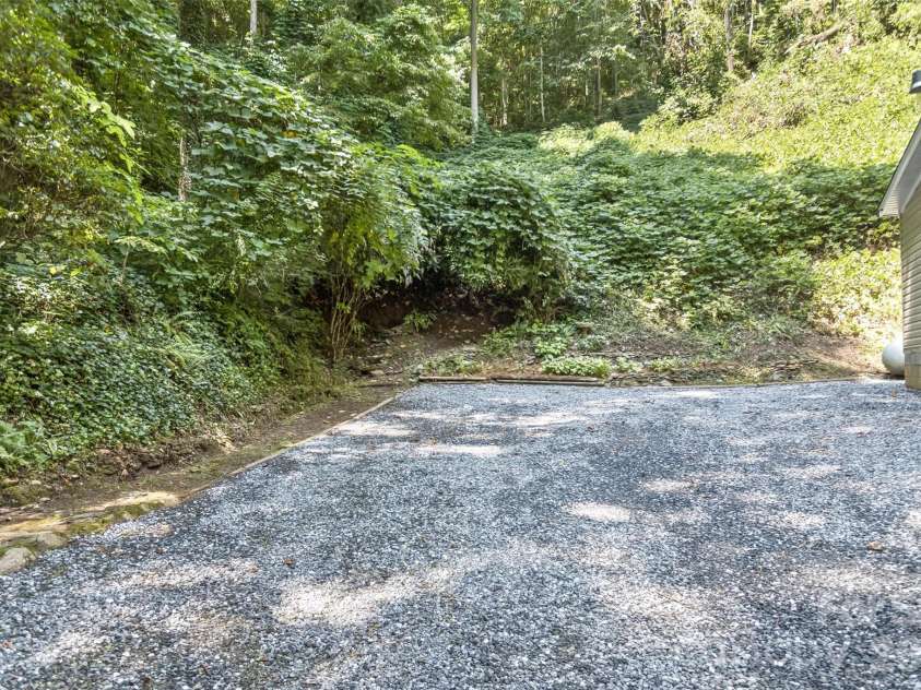 13 Cattail Drive, Sylva, NC 28779.  MLS# CAR4423552, YatesRealty ID 51604. Ample parking! and fresh gravel laid down