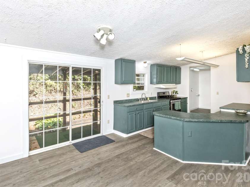 13 Cattail Drive, Sylva, NC 28779.  MLS# CAR4423552, YatesRealty ID 51604. Dining/Kitchen leads to back porch....