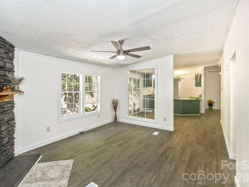 13 Cattail Drive, Sylva, NC 28779.  MLS# CAR4423552, YatesRealty ID 51604. Looking back into Kitchen and Living Room