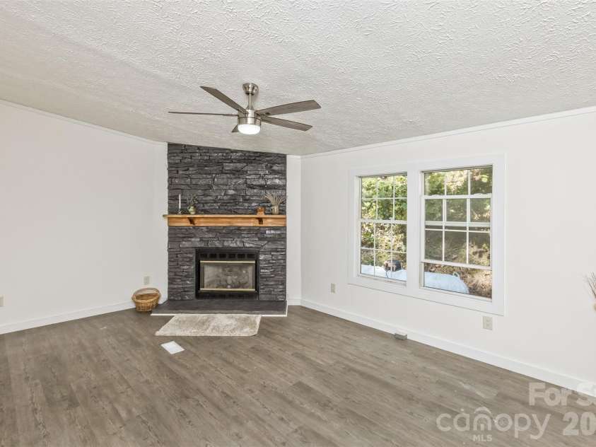 13 Cattail Drive, Sylva, NC 28779.  MLS# CAR4423552, YatesRealty ID 51604. Lovely Stone surround gas FP