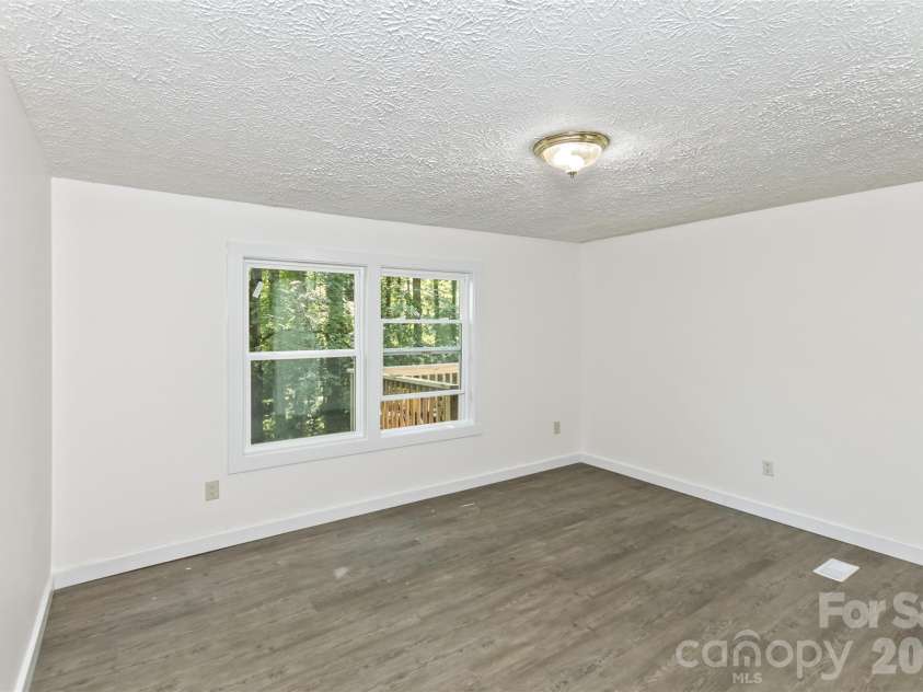 13 Cattail Drive, Sylva, NC 28779.  MLS# CAR4423552, YatesRealty ID 51604. Spacious and airy Primary Bedroom