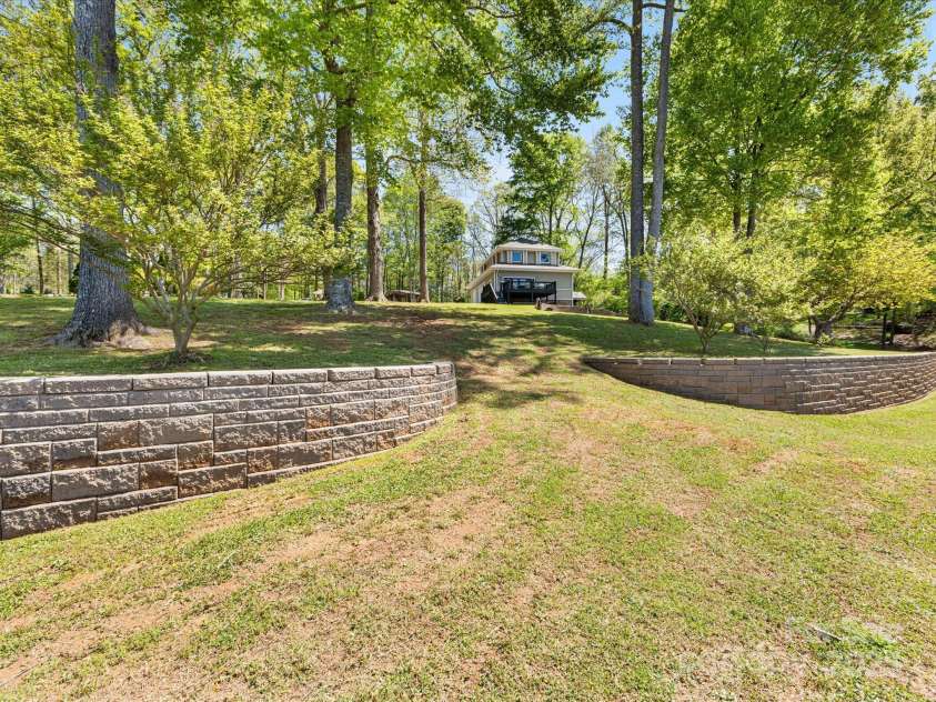 1395 Roundstone Road, Sherrills Ford, NC 28673.  MLS# CAR4243971, YatesRealty ID 5162. Lot slopes gently down to the water.