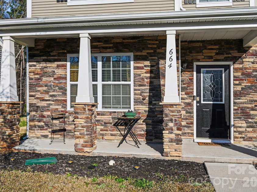 664 Saddlebred Lane, Locust, NC 28097.  MLS# CAR4360110, YatesRealty ID 5162. Large front porch with beautiful stone