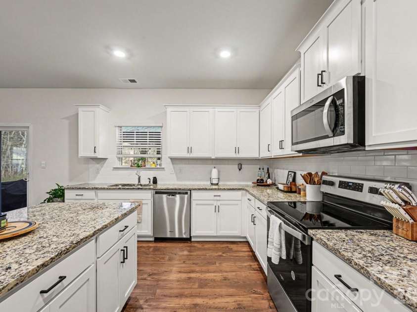 664 Saddlebred Lane, Locust, NC 28097.  MLS# CAR4360110, YatesRealty ID 5162. Large kitchen with lovely granite countertops
