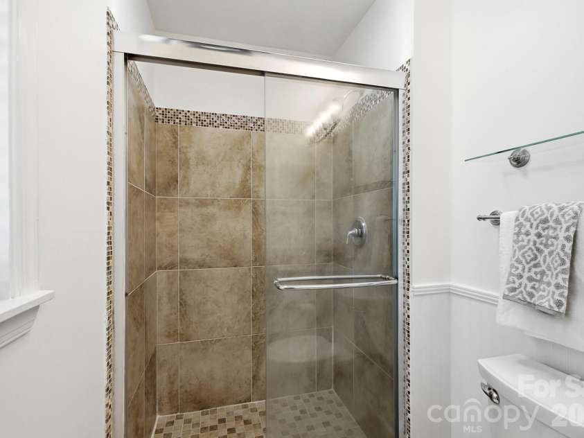 3022 Point Clear Drive, Tega Cay, SC 29708.  MLS# CAR4423199, YatesRealty ID 51620. Inviting primary bathroom with a fully tiled walk-in shower.