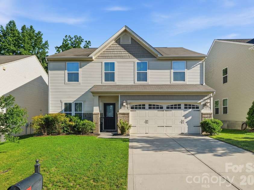 3341 Linetender Drive, Davidson, NC 28036.  MLS# CAR4425656, YatesRealty ID 51645. Attractive two-story exterior featuring a covered entry, two-car garage, and inviting curb appeal in The Farm at Riverpointe.