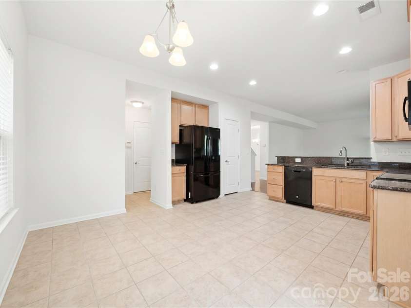 3341 Linetender Drive, Davidson, NC 28036.  MLS# CAR4425656, YatesRealty ID 51645. Kitchen: Open kitchen with generous cabinet storage, black appliances, and easy flow to the living and dining areas.