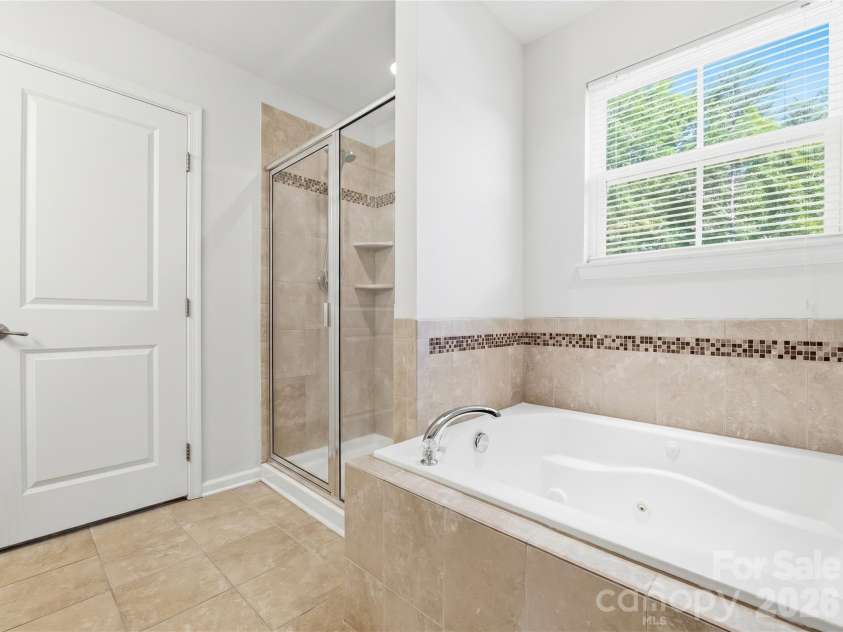 3341 Linetender Drive, Davidson, NC 28036.  MLS# CAR4425656, YatesRealty ID 51645. Primary Ensuite Bathroom: Primary bath featuring a jetted whirlpool tub, separate shower, and tile flooring.