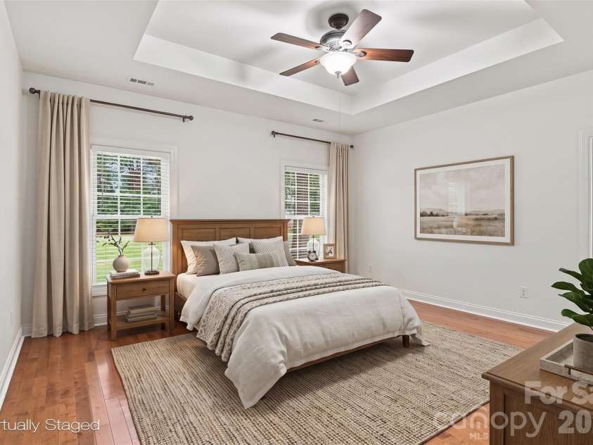 1524 Garrett Landen Drive, Clover, SC 29710.  MLS# CAR4418326, YatesRealty ID 51658. Virtually staged primary bedroom with trey ceiling, ceiling fan, and en suite bathroom!