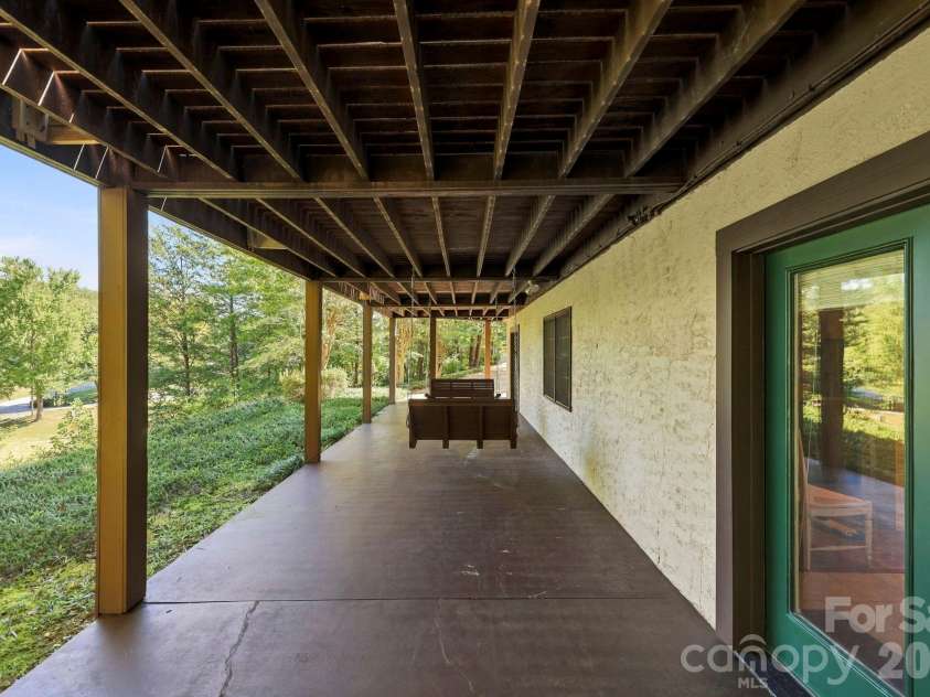 134 Raleigh Drive, Lake Lure, NC 28746.  MLS# CAR4423634, YatesRealty ID 51670. Concrete lower level with swings.