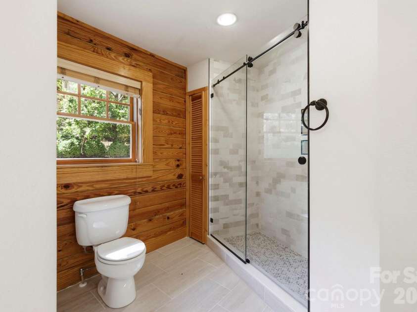 134 Raleigh Drive, Lake Lure, NC 28746.  MLS# CAR4423634, YatesRealty ID 51670. Primary bath view 2, lovely tile shower.