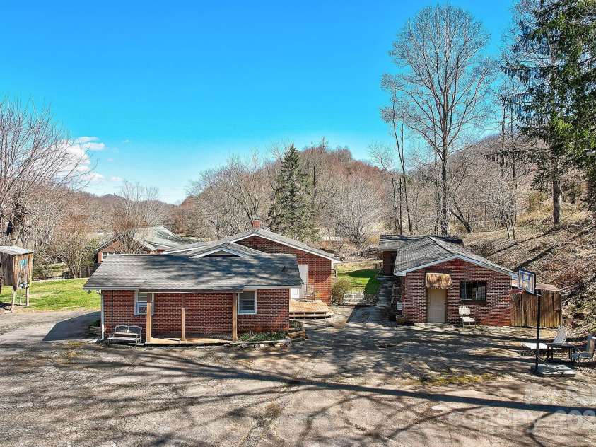 2541 Dellwood Road, Waynesville, NC 28786.  MLS# CAR4243546, YatesRealty ID 5168. Another drone shot of buildings and parking areafrom the side.